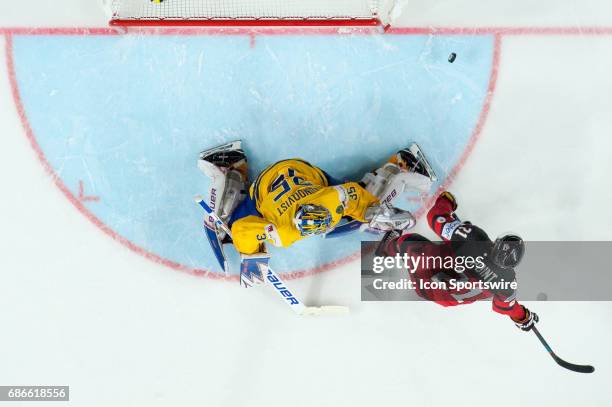 Goalie Henrik Lundqvist makes a save against Brayden Point in penalty shoot outs during the Ice Hockey World Championship Gold medal game between...