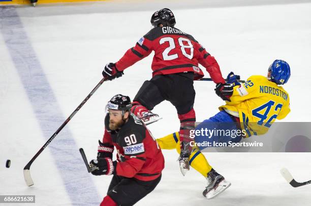 Claude Giroux clashes with Joakim Nordstrom during the Ice Hockey World Championship Gold medal game between Canada and Sweden at Lanxess Arena in...