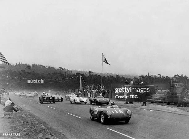 Jean Pierre Kunstle of the United States drives the Porsche 550 Spyder ahead of John Fox in the Cooper T39 and WR Turner driving the Porsche 550...