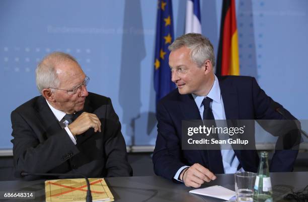 German Finance Minister Wolfgang Schaeuble and new French Finance Minister Bruno Le Maire chat after speaking to the media following talks on May 22,...