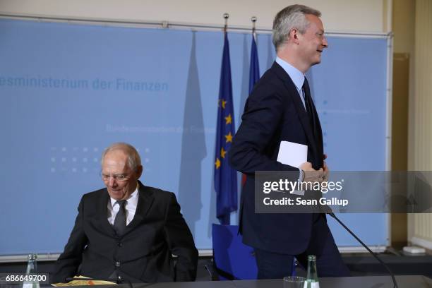 German Finance Minister Wolfgang Schaeuble and new French Finance Minister Bruno Le Maire depart after speaking to the media following talks on May...