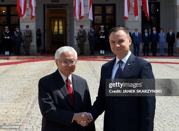 Polish President Andrzej Duda and Singapore's President Tony Tan Keng Yam shake hands during a welcoming ceremony at the court of the presidential...