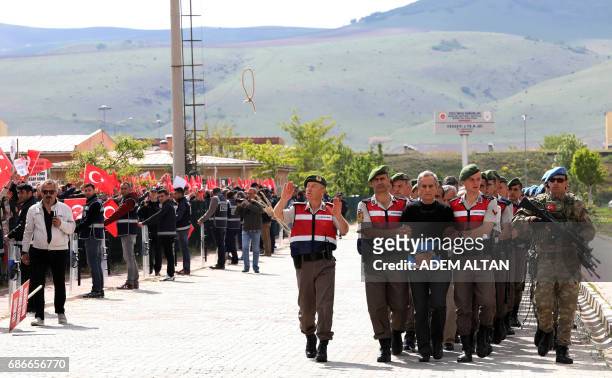 Protestors shout slogans and send ropes as Turkish Gendarmerie escort defendants Akin Ozturk and others involved in last Julys attempted coup in...
