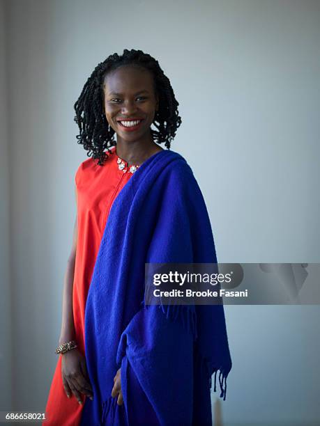 portrait of nigerian woman in red and blue - brooke fasani stock pictures, royalty-free photos & images