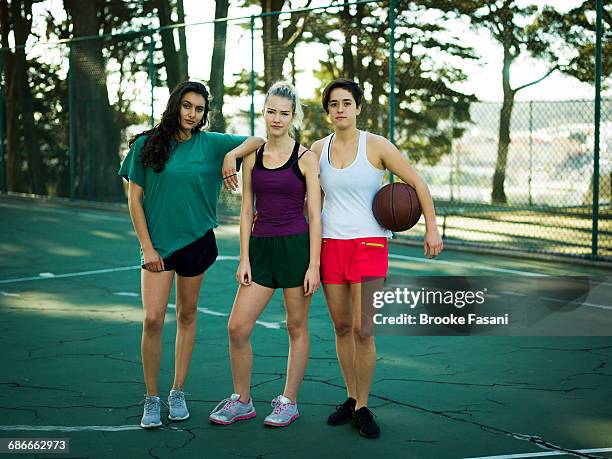 three girls on outdoor basketball court - teenage girl basketball stock pictures, royalty-free photos & images