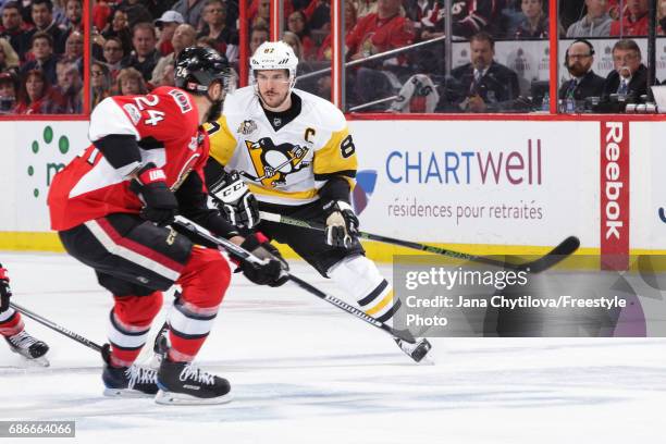 Sidney Crosby of the Pittsburgh Penguins defends against Viktor Stalberg of the Ottawa Senators in Game Four of the Eastern Conference Final during...