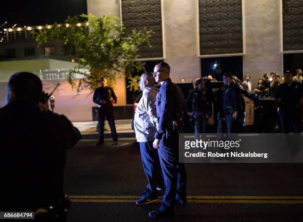 One of two suspects in a homicide stands in view of an eyewitness May 18, 2017 in the Hollywood section of Los Angeles, California. Los Angeles...
