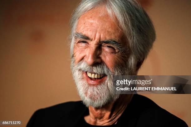 Austrian director Michael Haneke laughs on May 22, 2017 during a press conference for the film 'Happy End' at the 70th edition of the Cannes Film...