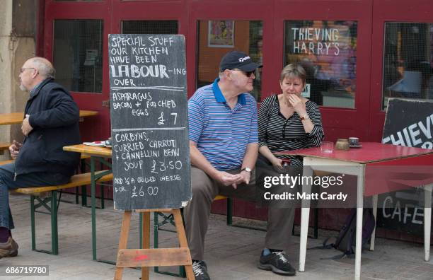 Members of the public watch as coach carrying Labour leader Jeremy Corbyn leaves from the launch of Labour's Cultural Manifesto at Fruit on May 22,...