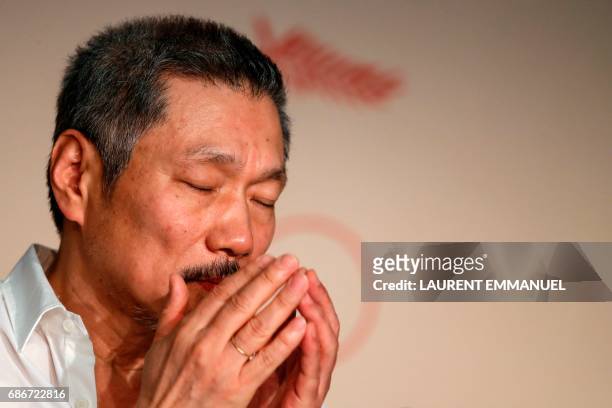South Korean director Hong Sangsoo attends on May 22, 2017 a press conference for the film 'Geu-Hu' at the 70th edition of the Cannes Film Festival...