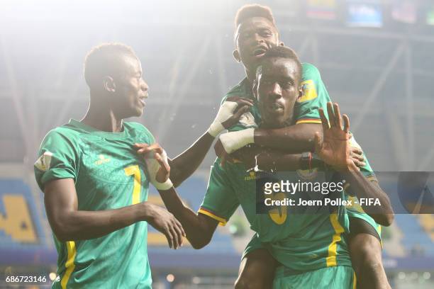 Diagne Cavin of Senegal celebrates with his team mates after scoring his team's second goal of Senegal compete for the ball during the FIFA U-20...