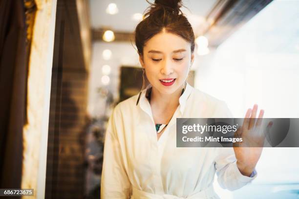 woman working in a fashion boutique in tokyo, japan. - einzelne frau über 40 stock-fotos und bilder