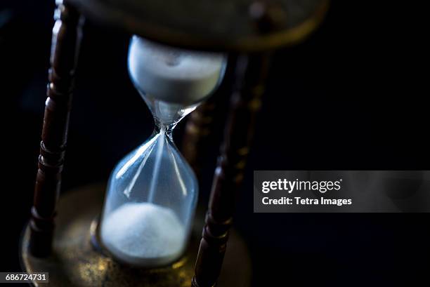 studio shot of hourglass - time travel stock pictures, royalty-free photos & images