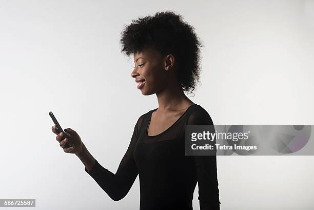young woman with mobile phone - neckline stock pictures, royalty-free photos & images