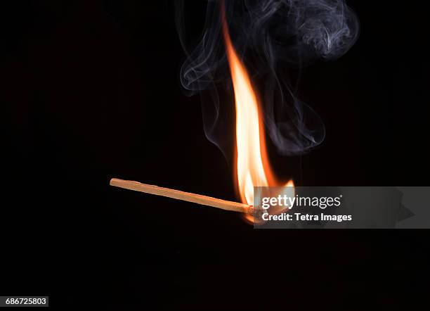 studio shot of burning match - match lighting equipment stock pictures, royalty-free photos & images