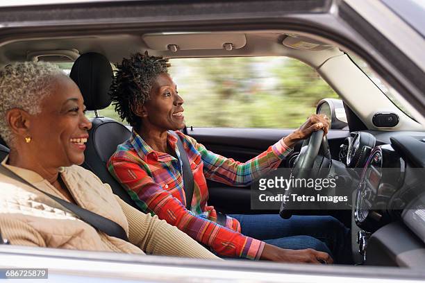 Two smiling women in car