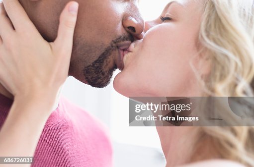 Multi ethnic couple kissing Multi ethnic couple kissing