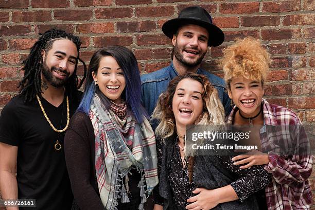 portrait of happy friends against brick wall - greek ethnicity stock pictures, royalty-free photos & images