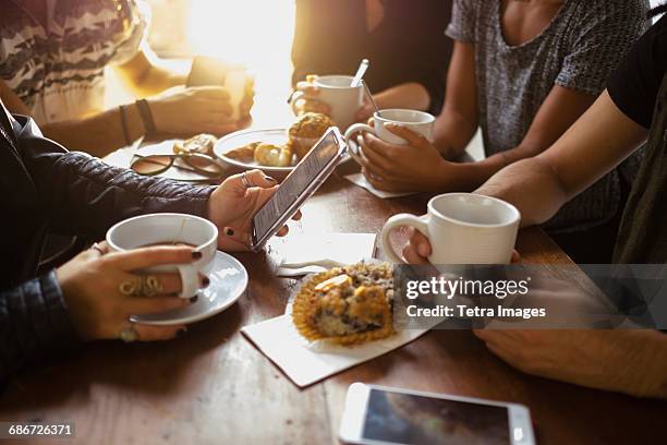 group of friends in cafe - coffee cups table stock pictures, royalty-free photos & images