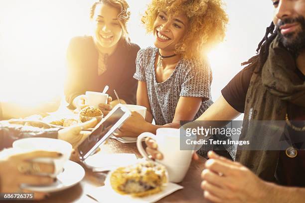 group of friends in cafe - african american restaurant texting stockfoto's en -beelden