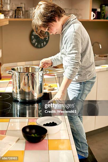 little boy cooking in the kitchen - stirring stock pictures, royalty-free photos & images