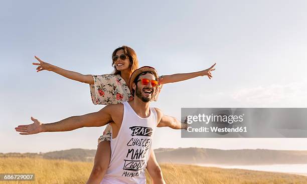 couple in love having fun near the coast - inviting gesture stock pictures, royalty-free photos & images