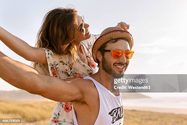 couple having fun near the coast - couple on beach sunglasses stock pictures, royalty-free photos & images