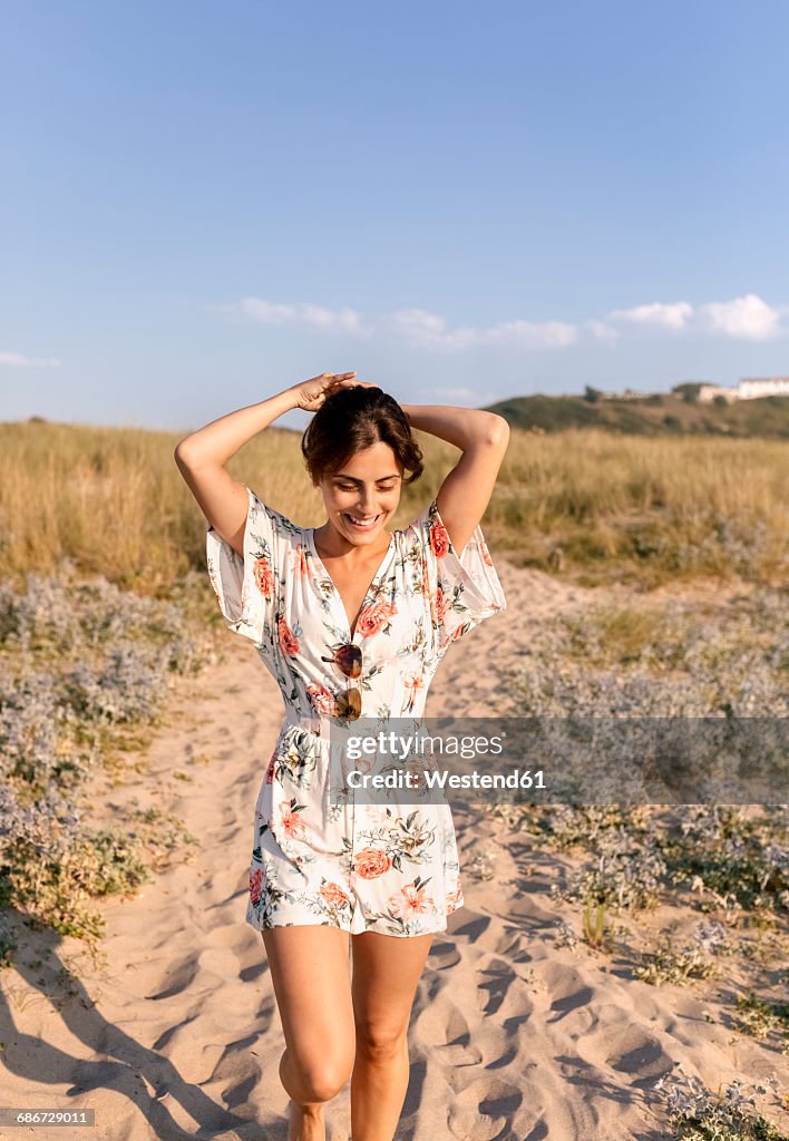 Smiling woman on the beach at evening twilight