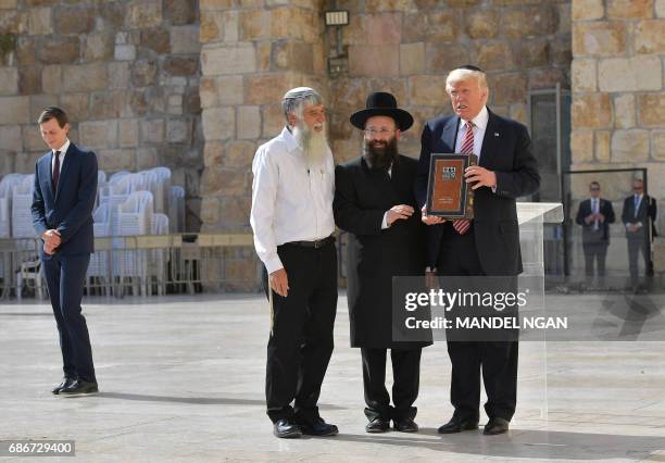President Donald Trump stands near Rabbi Shmuel Rabinovitch during a visit to the Western Wall, the holiest site where Jews can pray, in Jerusalem's...