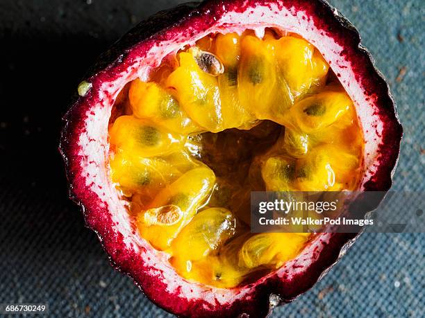 elevated view of passion fruit cut in half - passievrucht stockfoto's en -beelden