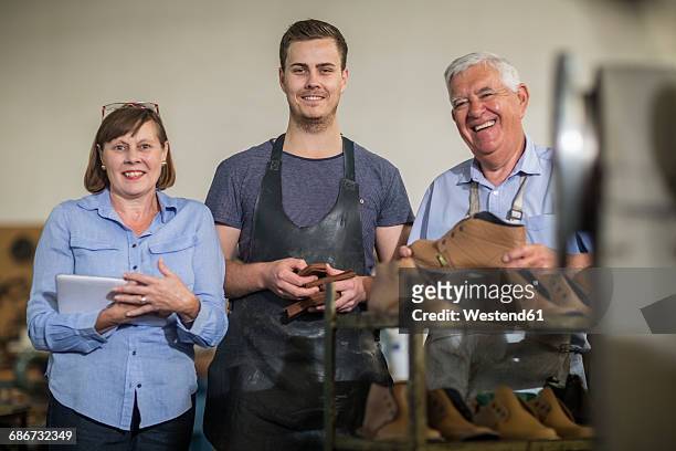 portrait of smiling staff in shoemaker's workshop - footwear manufacturing stock pictures, royalty-free photos & images