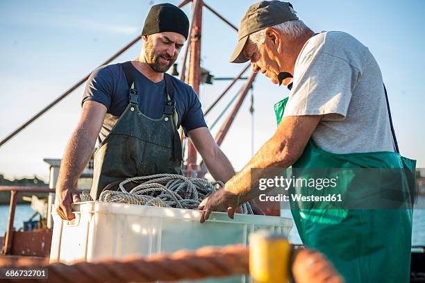 fishermen working on trawler - fisherman stock pictures, royalty-free photos & images