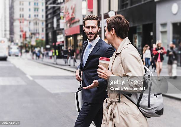 usa, new york city, businessman and woman walking in manhattan - businesswoman nyc stock pictures, royalty-free photos & images