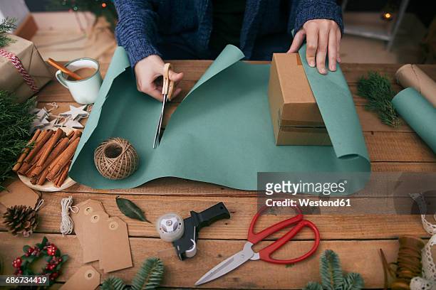 woman wrapping christmas gifts - wrapping paper stock-fotos und bilder