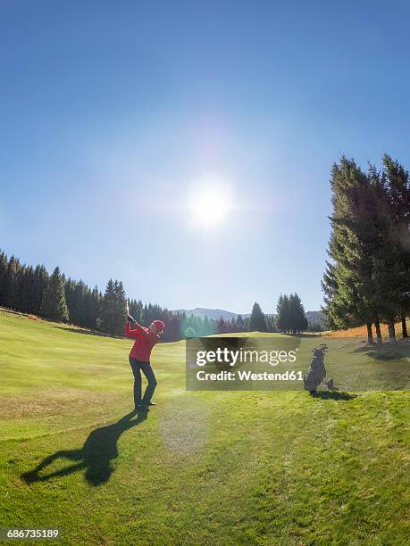 italy, veneto, dolomites, golfer on golf course - golf swing motion stock pictures, royalty-free photos & images