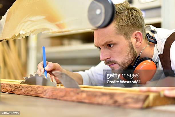 carpenter at work in his workshop - kreissäge stock-fotos und bilder