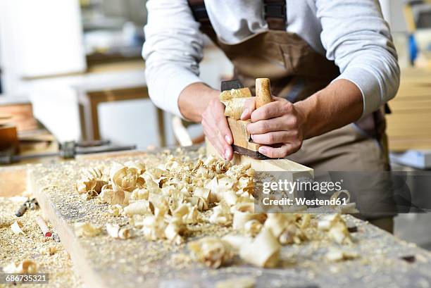 carpenter working with plane in workshop - wood sawdust stock pictures, royalty-free photos & images