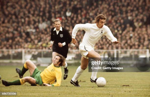 Martin Chivers of Spurs leaves behind Norwich player Doug Livermore as referee David Smith looks on during the 1973 League Cup Final between Norwich...