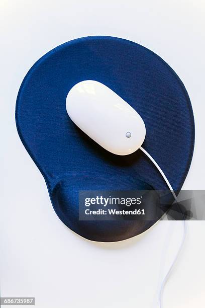 white mouse on blue ergonomic mouse pad - mouse pad stock pictures, royalty-free photos & images