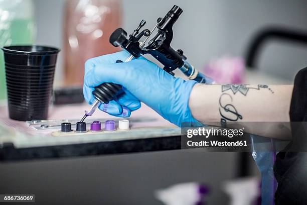 tattoo artist in studio preparing - tattoo needle stock pictures, royalty-free photos & images