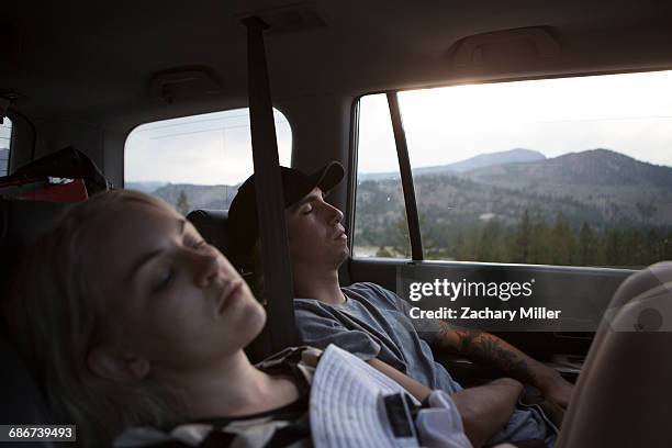 "young woman and woman asleep in car, mammoth lakes, california, usa" - sleeping in car stockfoto's en -beelden