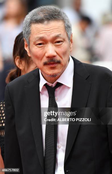 South Korean director Hong Sangsoo arrives on May 22, 2017 for the screening of the film 'Geu-Hu' at the 70th edition of the Cannes Film Festival in...
