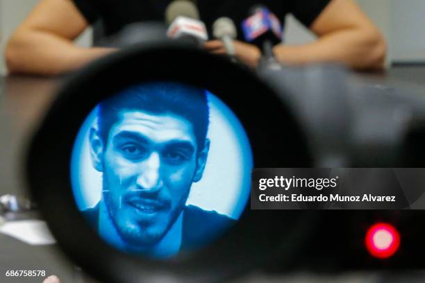 Turkish NBA Player Enes Kanter, seen through a video camera, speaks to the media during a news conference about his detention at a Romanian airport...