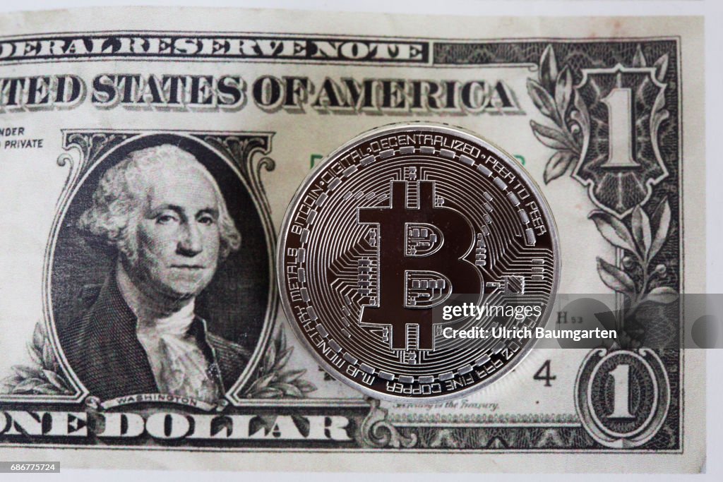Bitcoin physically on a dollar banknote.