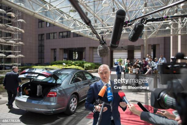 Pierre Moscovici, economic commissioner for the European Union , speaks to journalists as he arrives ahead of a Eurogroup meeting of European finance...