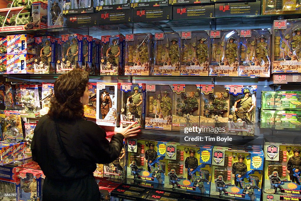 A shopper looks at a wall of G.I. Joe action figures and