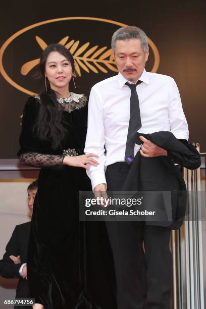 Kim Min-hee and director Hong Sang-soo depart after the "The Day After " screening during the 70th annual Cannes Film Festival at Palais des...