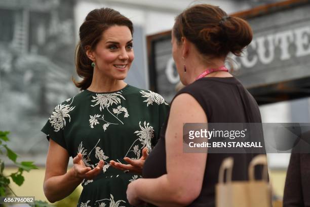 Britain's Catherine, Duchess of Cambridge , talks to an exhibitor as she visits the Chelsea Flower Show in London on May 22, 2017. The Chelsea flower...