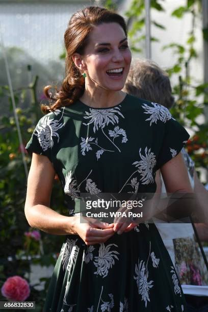 Catherine, Duchess of Cambridge reacts after trying a tomato at the 'BBC Radio 2: Chris Evans Taste Garden' during her visit the RHS Chelsea Flower...