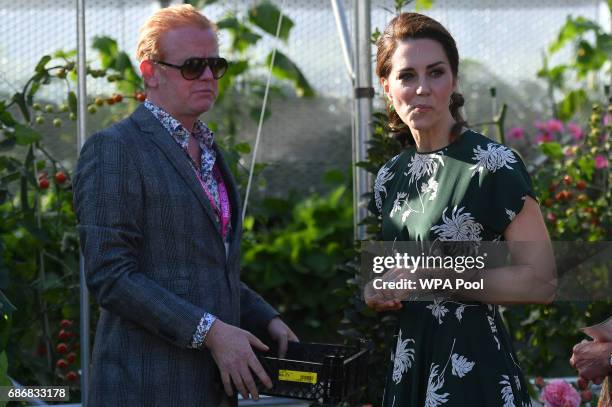 Radio 2 presenter Chris Evans watches as Catherine, Duchess of Cambridge, samples a tomato at the 'BBC Radio 2: Chris Evans Taste Garden' during her...